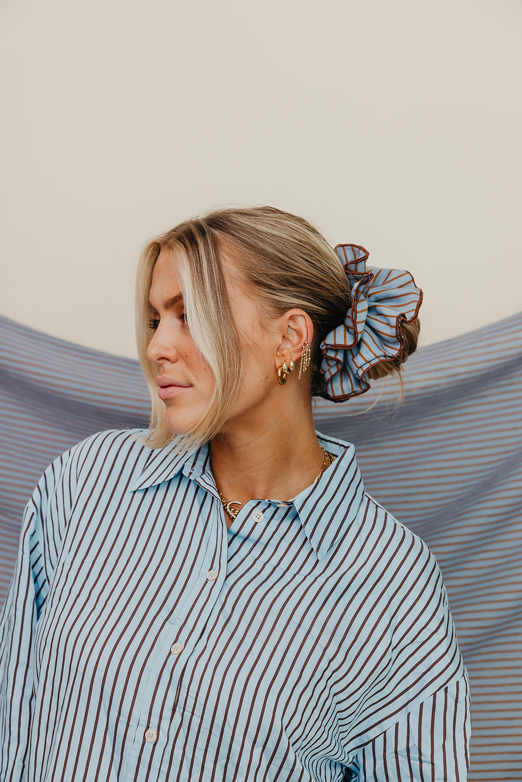 KAXI Blue + Brown striped corset scrunchie worn in a bun