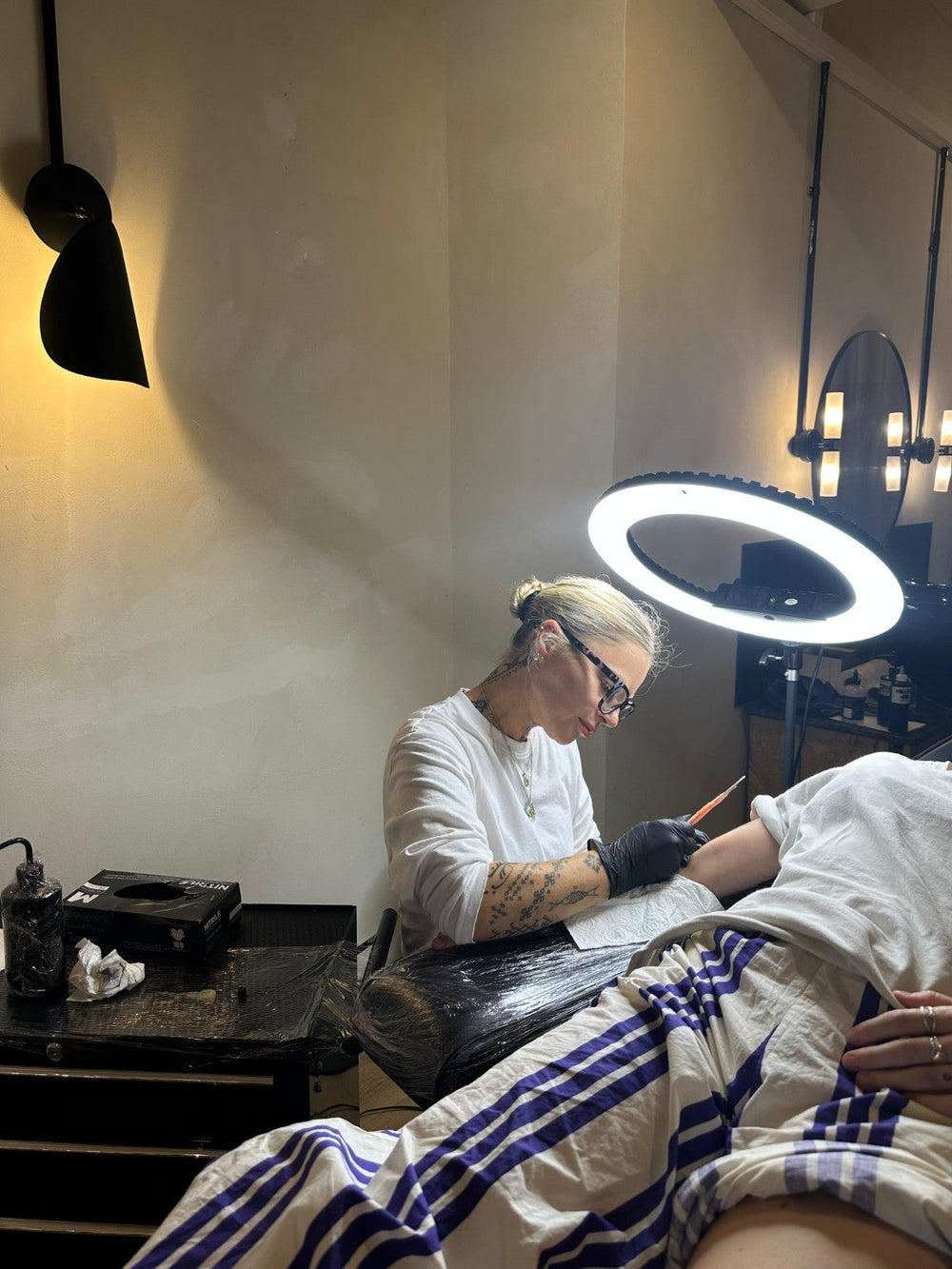 Beth hand-poking a tattoo at SHY